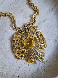 Vintage Nina Ricci Gold Bow Necklace with Amber Glass Center