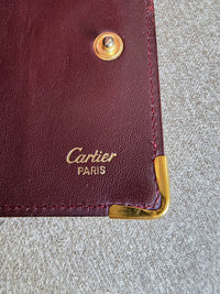Porté clé multi clé Cartier en cuir lisse bordeaux et bijouterie dorée