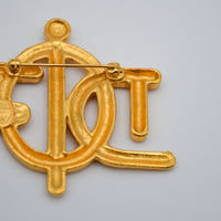 Broche Christian Dior Logo