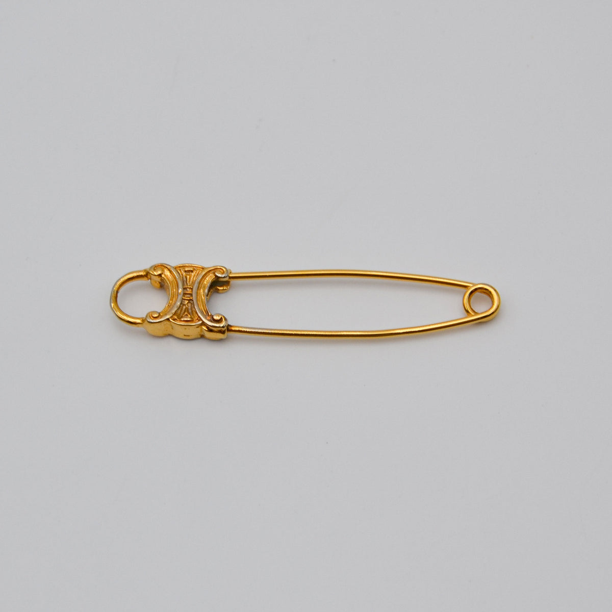 Broche Céline épingle logo Triomphe