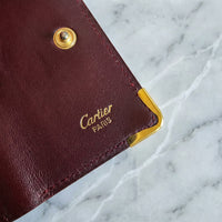 Porté clé multi clé Cartier en cuir lisse bordeaux et bijouterie dorée