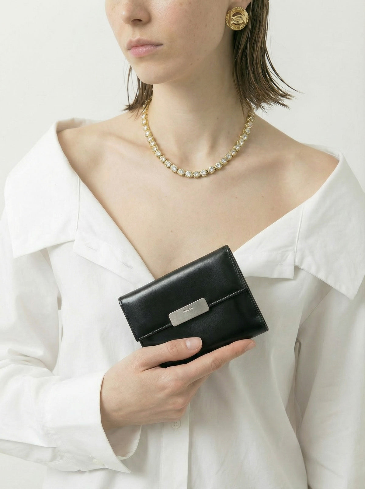 Portefeuille compact Prada en cuir noir